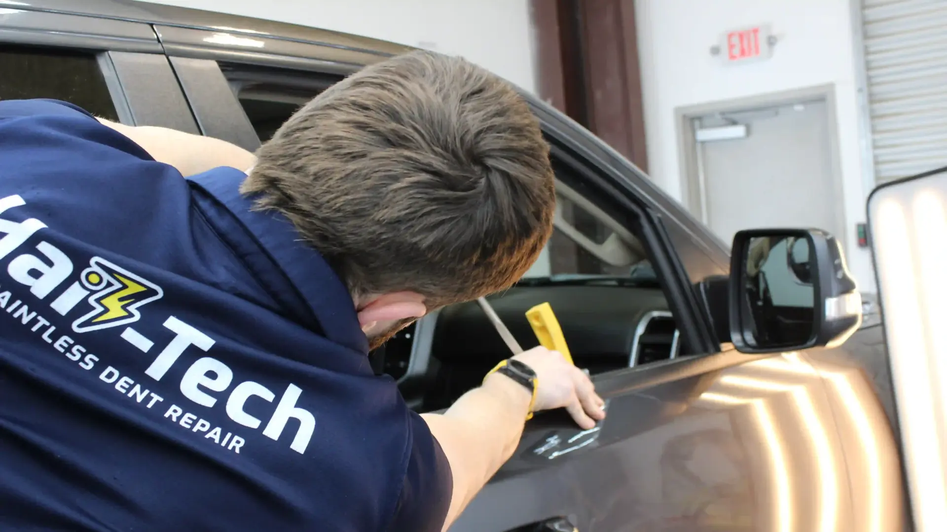 How Long Does Paintless Dent Repair Take? 1 PDR technician working on a minor door dent.