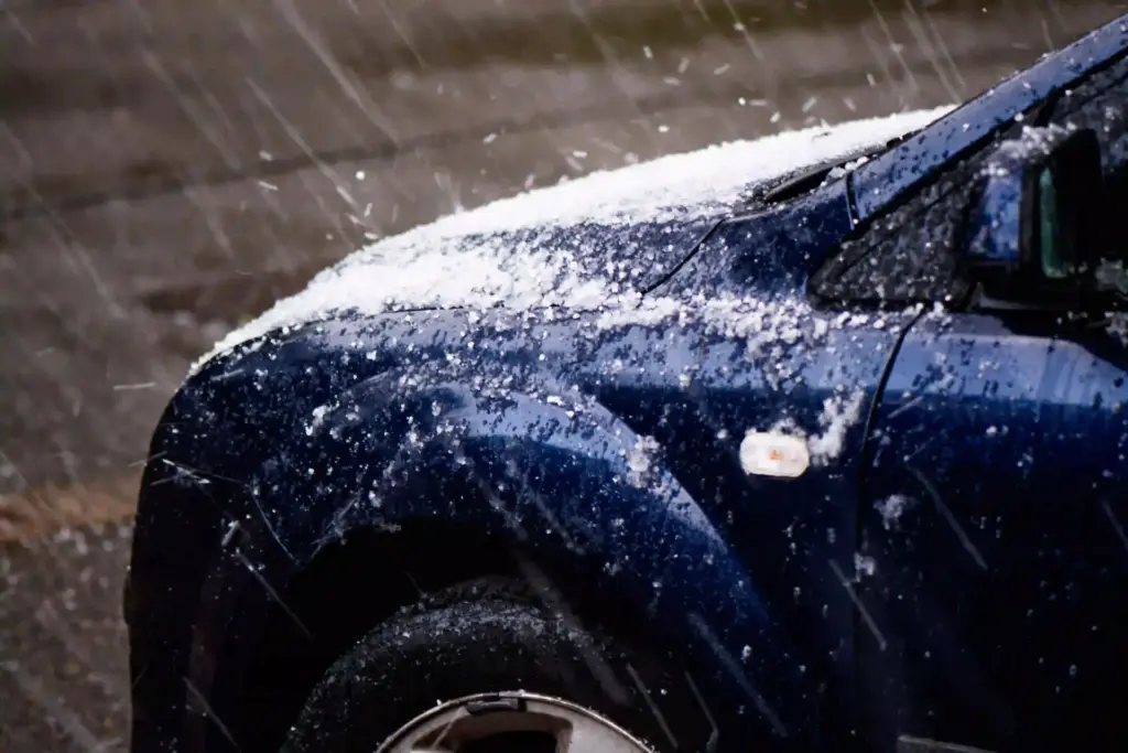 A car being pelted with hail during a hailstorm.