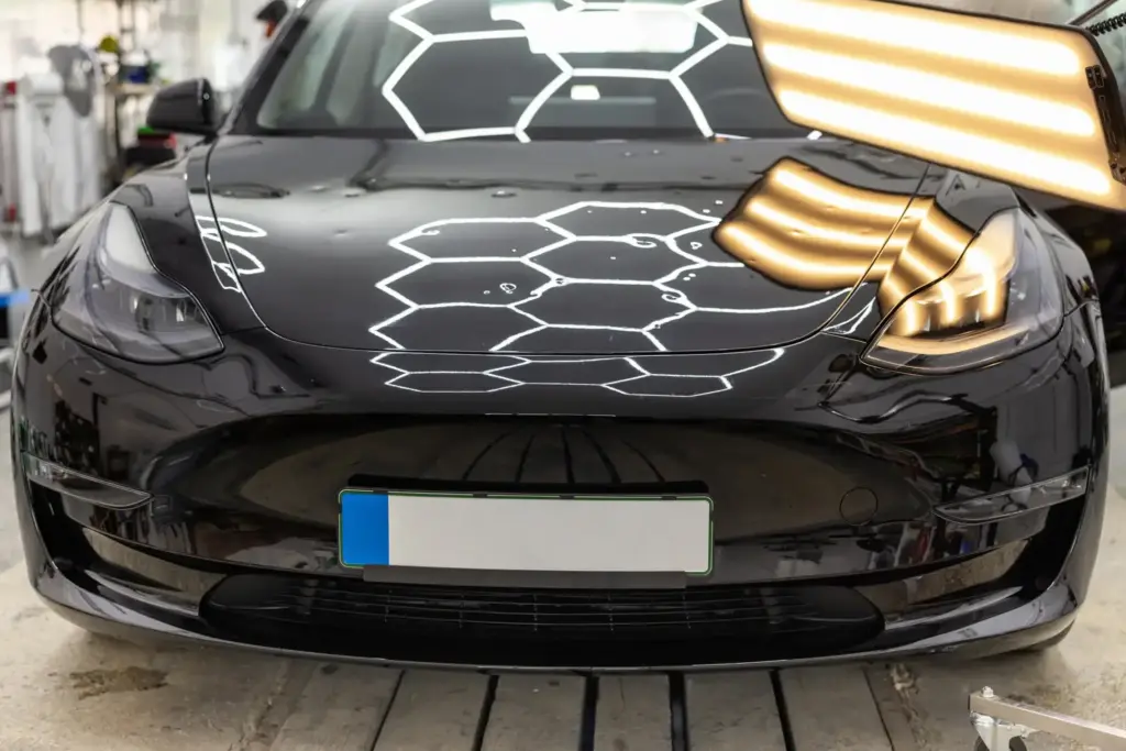 Special lighting to highlight hail damage and minor dents on a car.