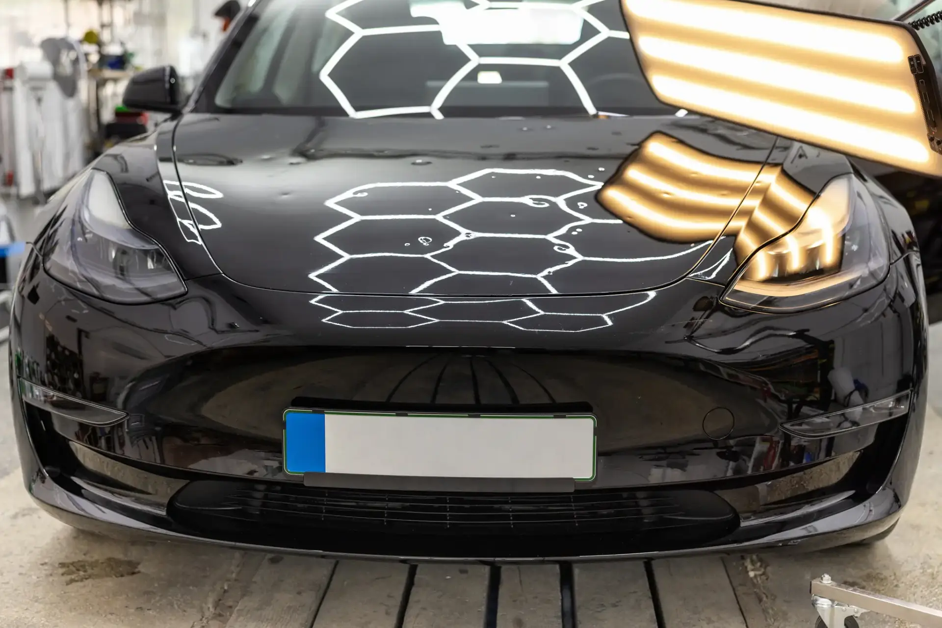 Special lighting to highlight hail damage and minor dents on a car.