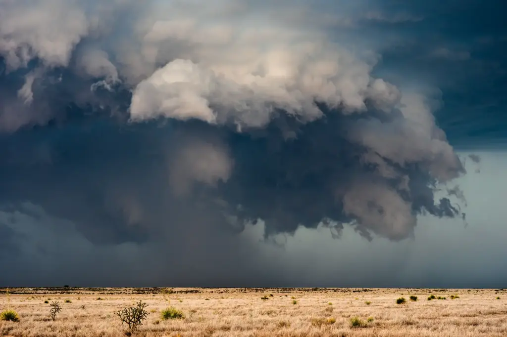 A dark supercell storm cloud building over the open plains of Hail Alley